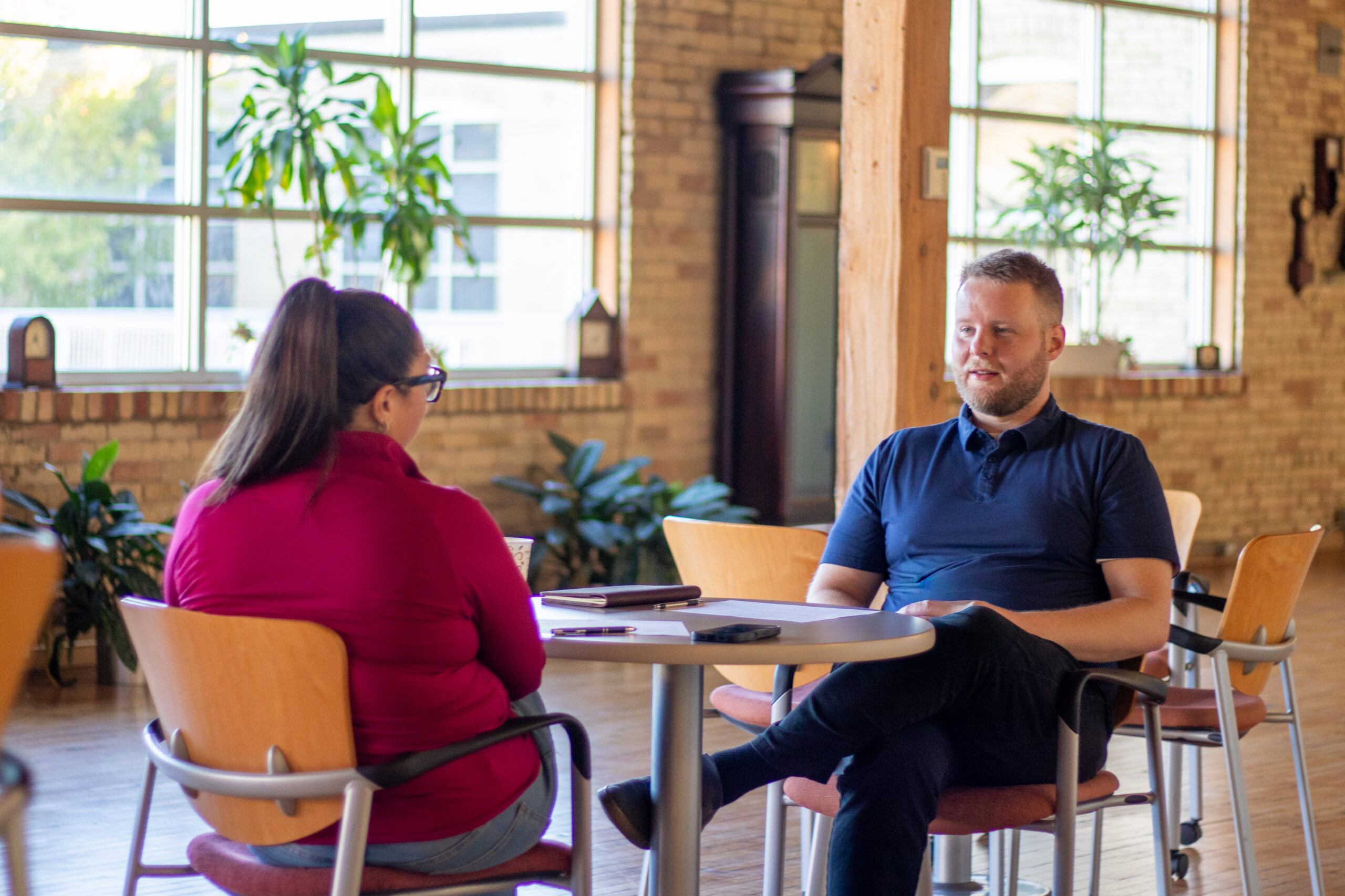 Two people in a cohort group discussing together