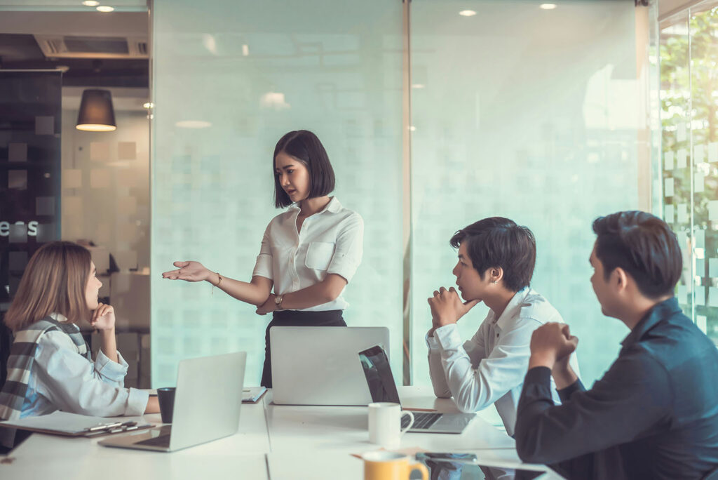 Manager exercising discernment while leading a team discussion in a modern office