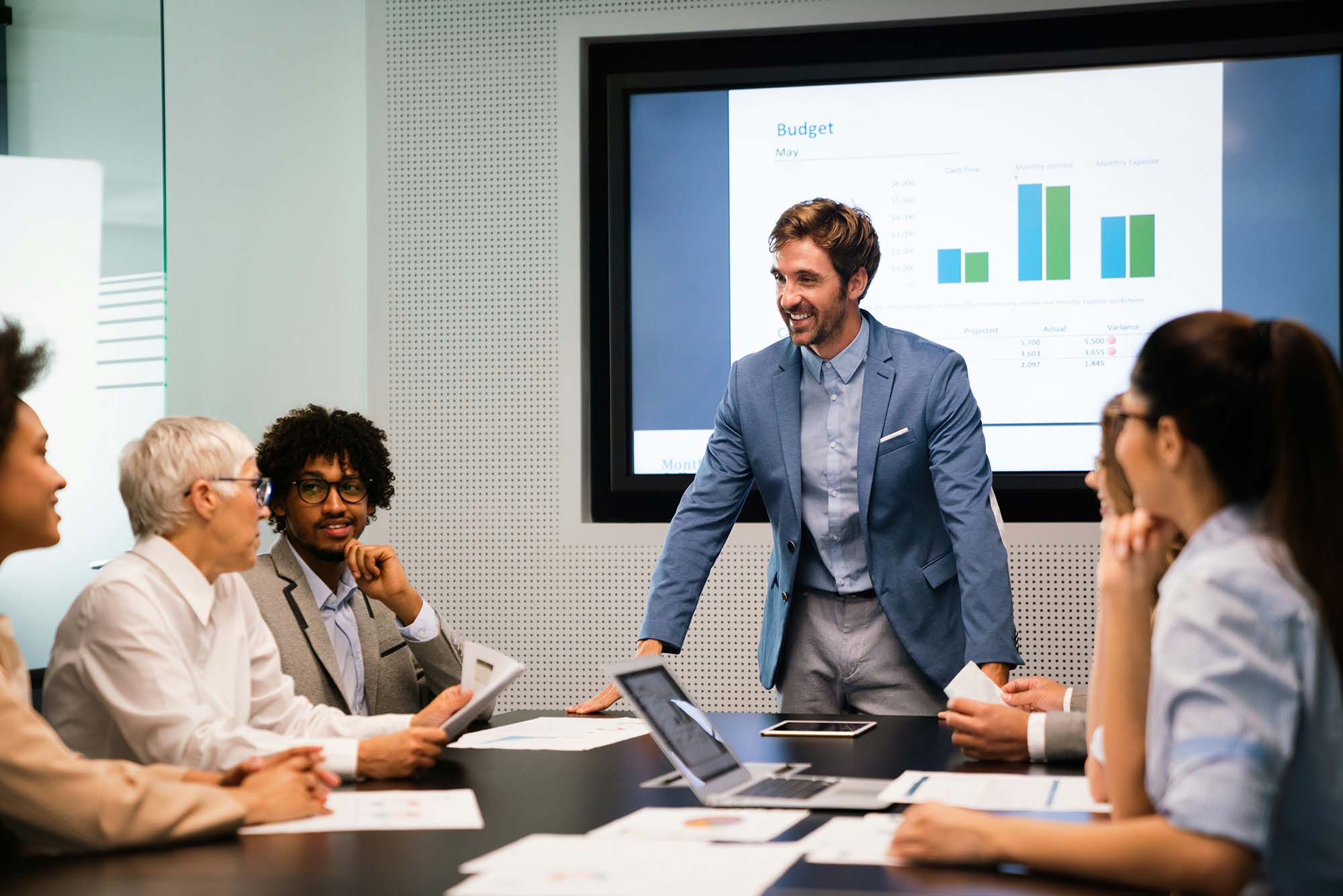 Leader facilitating a team debrief at a conference table